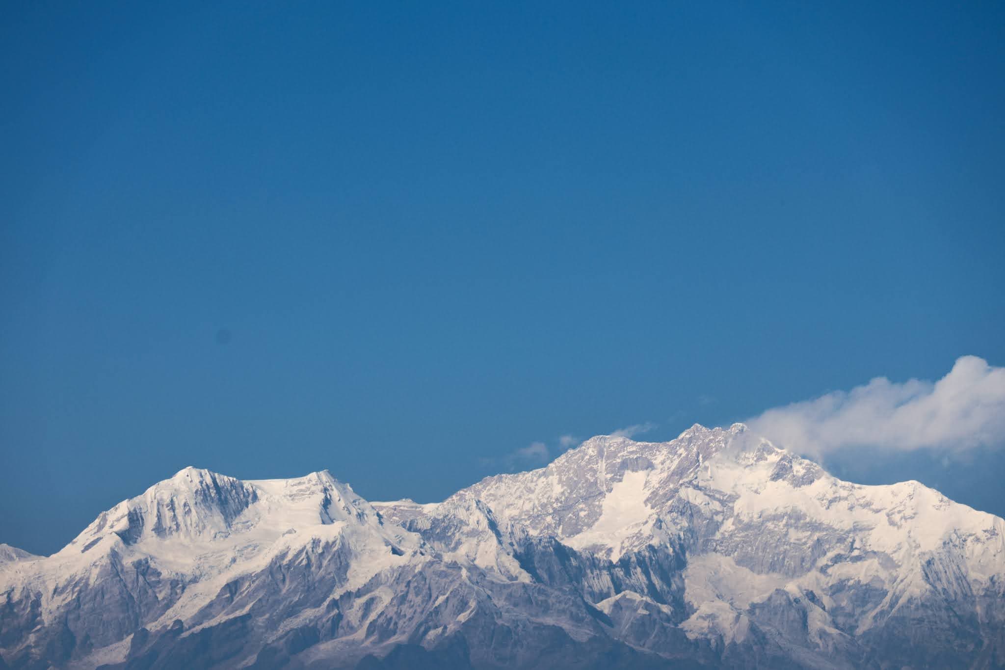 Snow-covered mountain peaks against blue sky